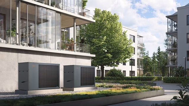 Commercial heat pump units installed outside modern residential apartments