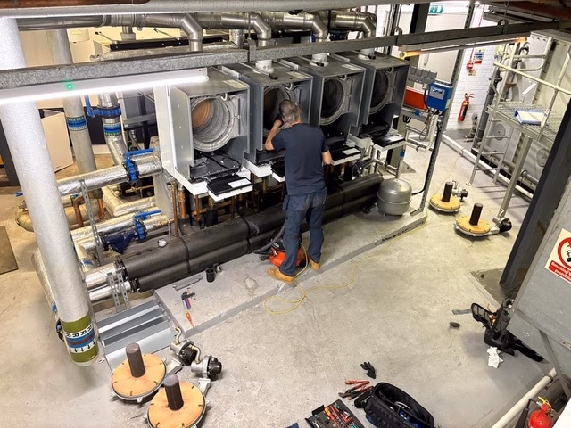 Engineer servicing commercial HVAC and plant room equipment